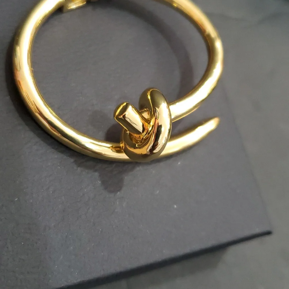Eye Candy gold tone knot and point open‎ cuff hinged bracelet bangle brand new